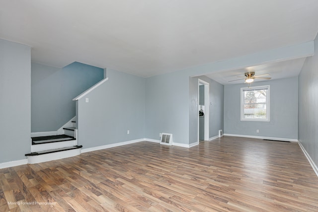 unfurnished living room with hardwood / wood-style floors and ceiling fan