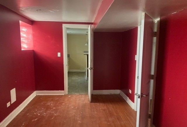 hallway with wood-type flooring