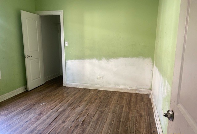 unfurnished room featuring hardwood / wood-style flooring