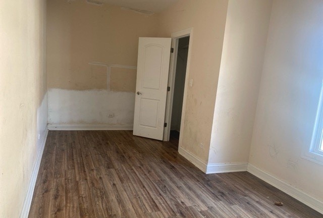 unfurnished room featuring dark hardwood / wood-style floors