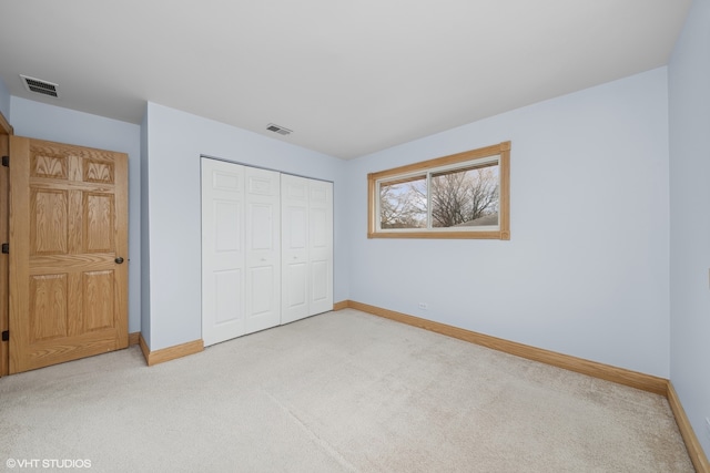 unfurnished bedroom featuring a closet and carpet floors