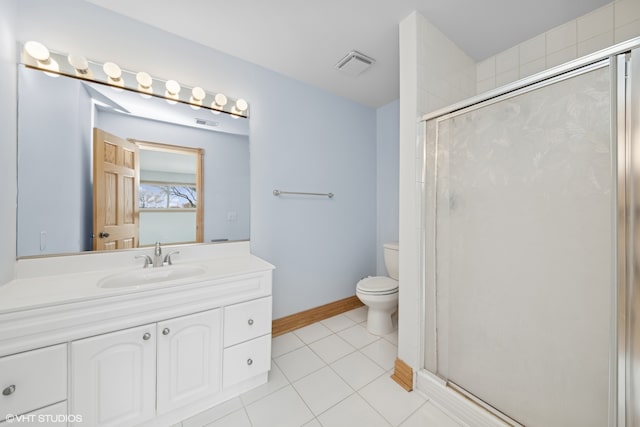 bathroom featuring toilet, vanity, tile patterned floors, and walk in shower