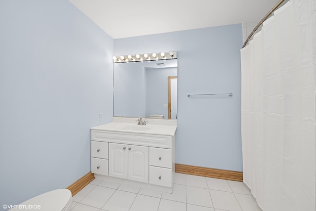 bathroom with tile patterned floors, vanity, and toilet