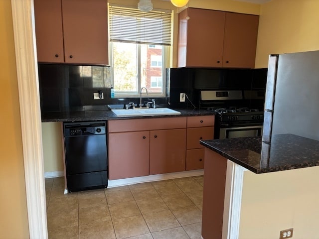 kitchen with black appliances, tasteful backsplash, light tile patterned floors, sink, and dark stone countertops