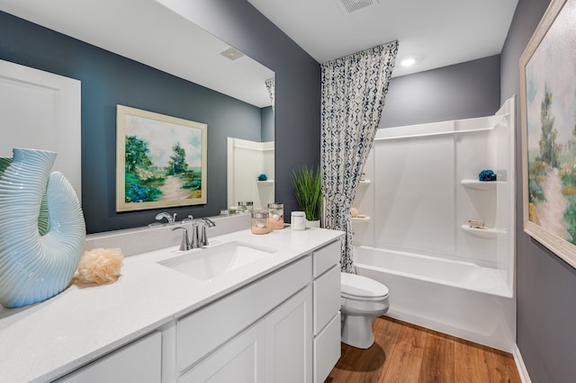 full bathroom with toilet, vanity, shower / bath combo with shower curtain, and wood-type flooring