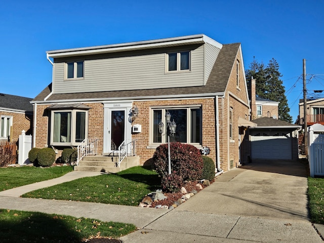 view of front facade with an outbuilding, a garage, and a front yard