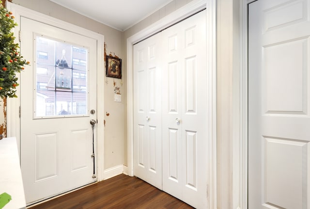 doorway to outside featuring ornamental molding and dark wood-type flooring