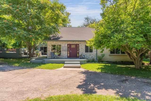 obstructed view of property with a front lawn