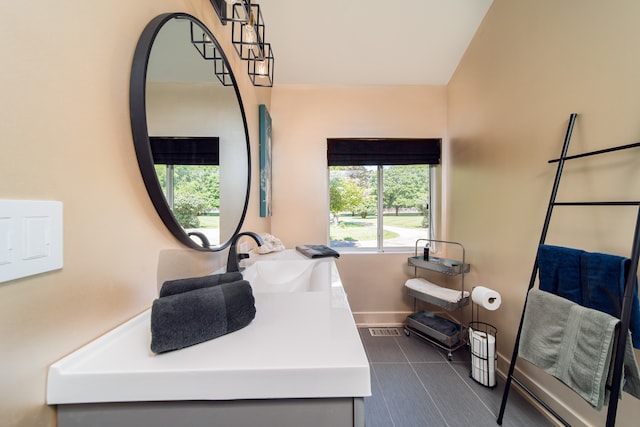 bathroom featuring vanity and vaulted ceiling