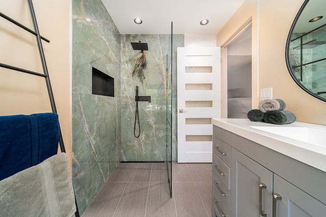 bathroom with vanity, tile patterned floors, and a tile shower