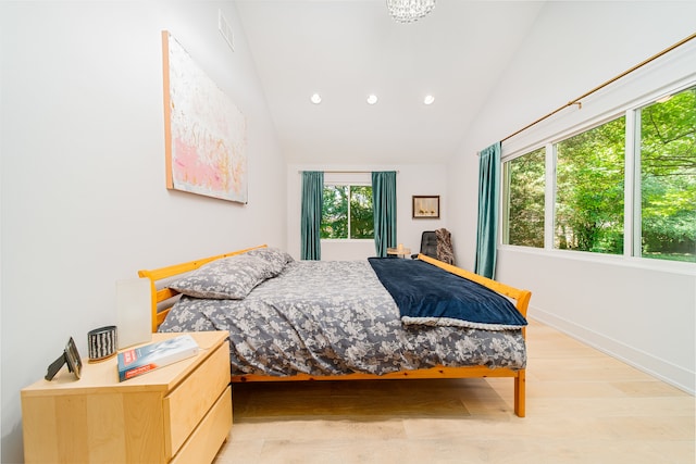 bedroom featuring light wood-type flooring and lofted ceiling