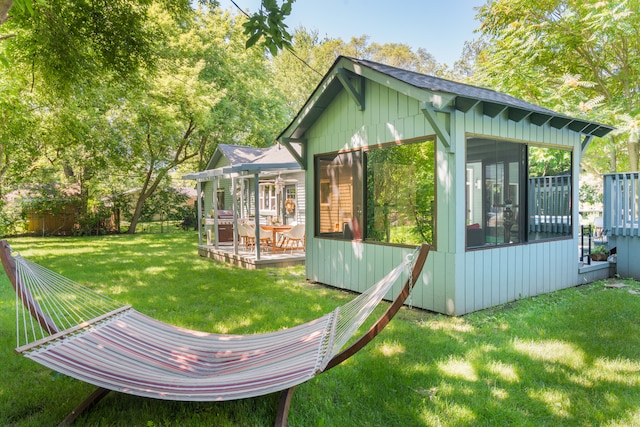 exterior space featuring a lawn and a sunroom