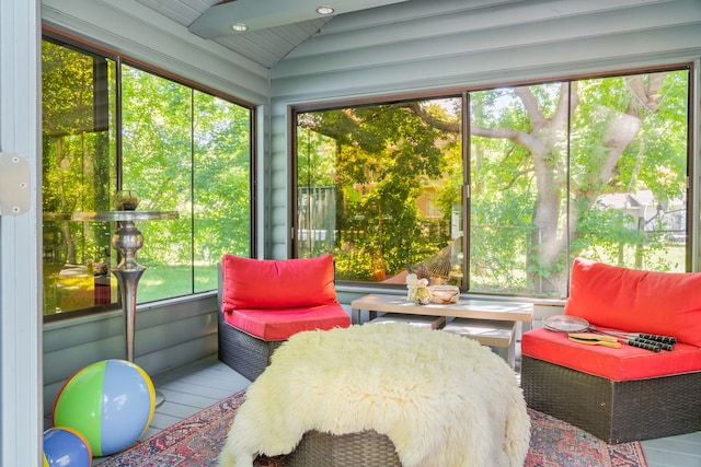 sunroom / solarium with a wealth of natural light and lofted ceiling