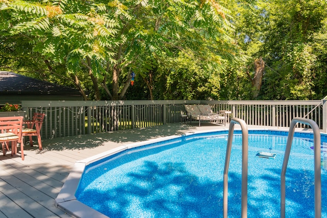 view of pool with a wooden deck