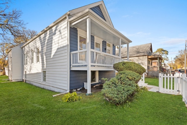 view of home's exterior with a lawn and covered porch