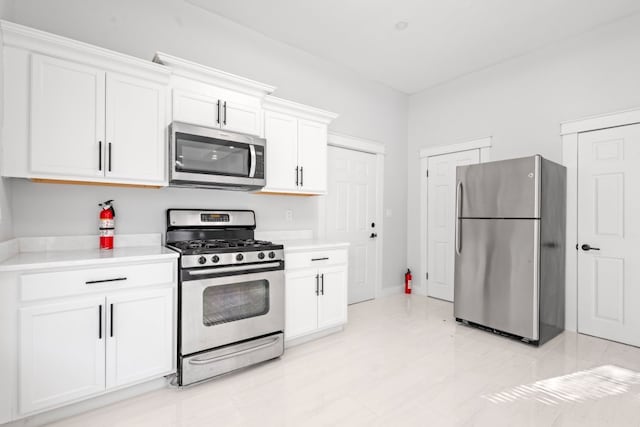 kitchen with white cabinets and appliances with stainless steel finishes