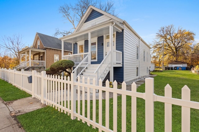 bungalow-style house with covered porch and a front lawn