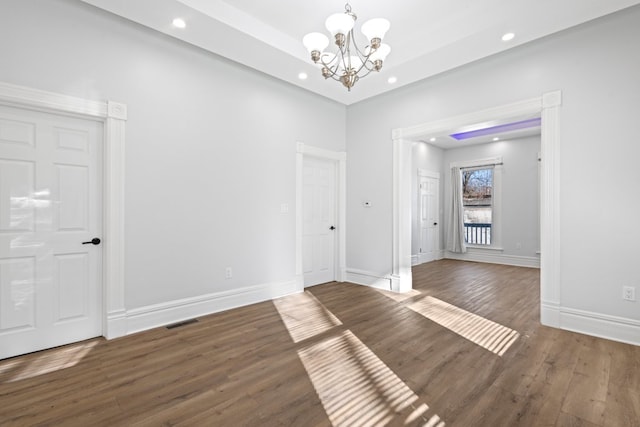 interior space featuring dark hardwood / wood-style floors and a notable chandelier