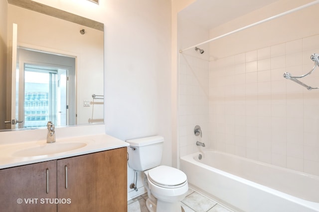 full bathroom featuring tile patterned flooring, tiled shower / bath combo, toilet, and vanity