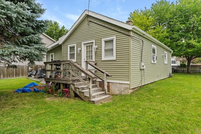 back of house with a lawn, a wooden deck, and cooling unit