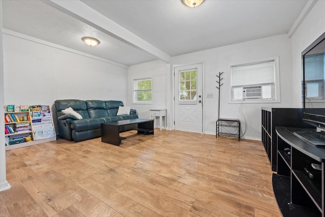 living room with cooling unit and light hardwood / wood-style flooring