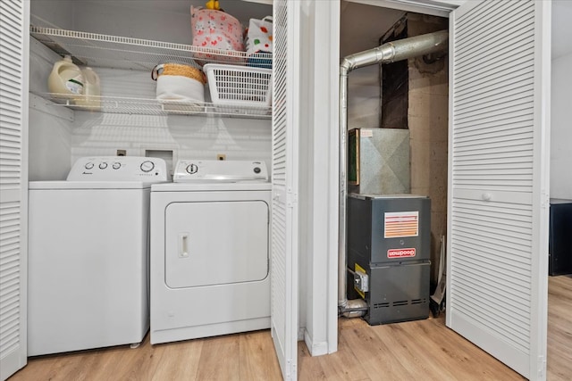 laundry room featuring light wood-type flooring and washing machine and dryer