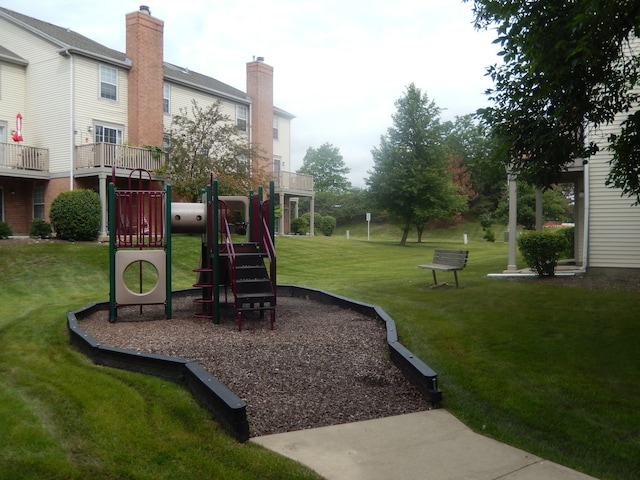 view of playground with a lawn