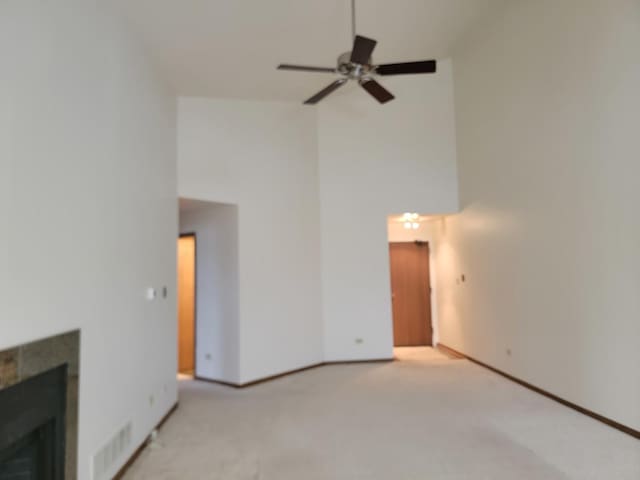 carpeted living room with ceiling fan