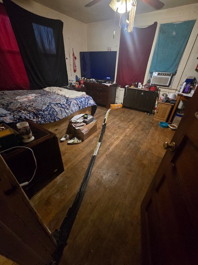 bedroom featuring wood-type flooring and ceiling fan