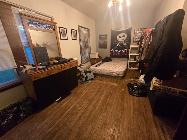 bedroom with dark hardwood / wood-style flooring