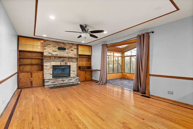 unfurnished sunroom with a healthy amount of sunlight, lofted ceiling with skylight, and wood ceiling