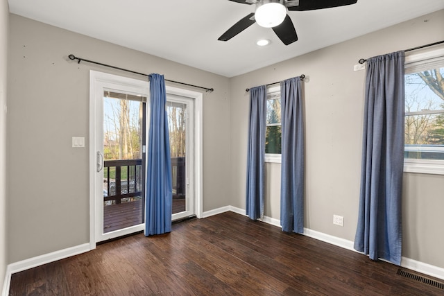 empty room featuring dark hardwood / wood-style flooring and ceiling fan