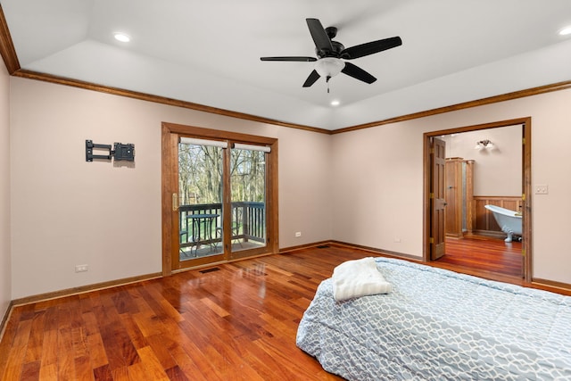 bedroom featuring lofted ceiling, a raised ceiling, hardwood / wood-style flooring, access to outside, and ornamental molding