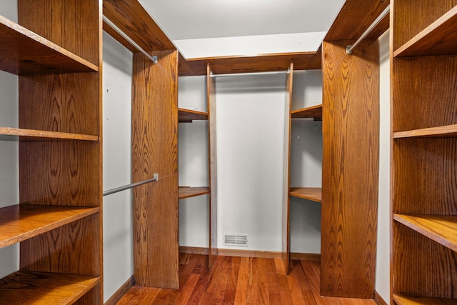 spacious closet with hardwood / wood-style flooring