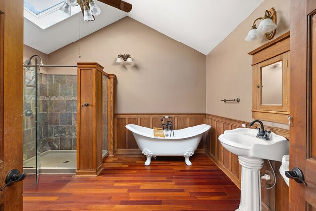 bathroom featuring lofted ceiling with skylight, independent shower and bath, wood walls, and hardwood / wood-style flooring