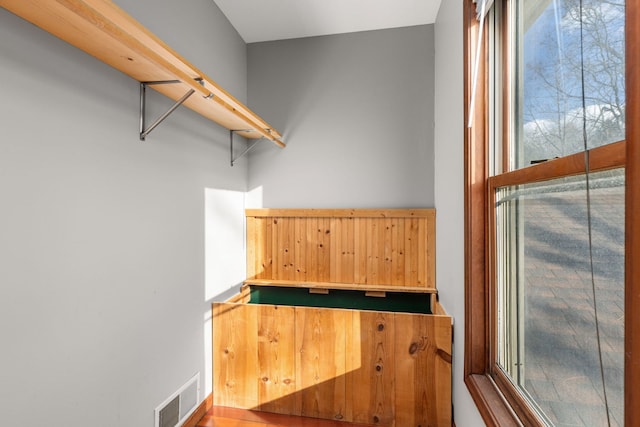 spare room featuring hardwood / wood-style flooring, plenty of natural light, ornamental molding, and ceiling fan