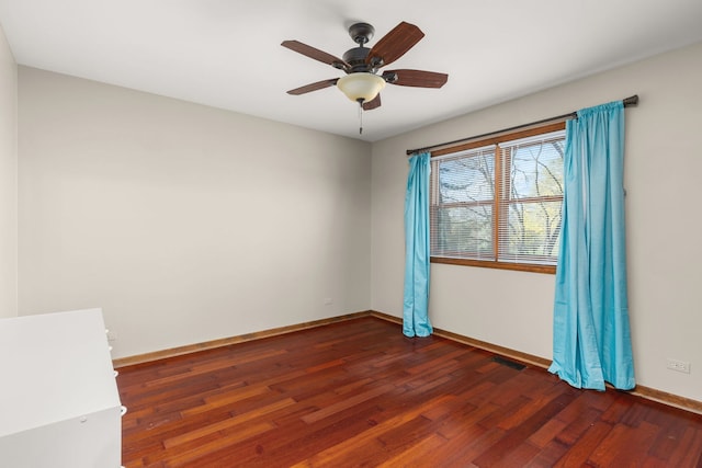 unfurnished room with ceiling fan and dark hardwood / wood-style flooring