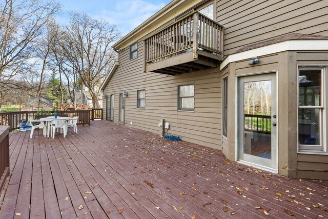 deck with a yard, a playground, and a sunroom