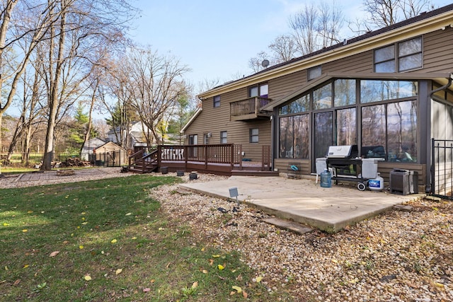 view of yard featuring a fire pit, an outbuilding, and a deck