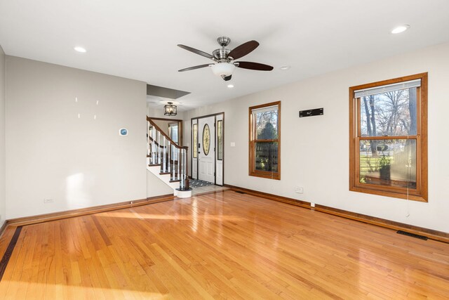 empty room featuring hardwood / wood-style flooring and ceiling fan