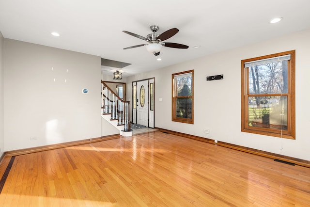 spare room featuring light hardwood / wood-style floors, a wealth of natural light, and ceiling fan