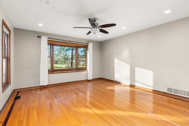 spare room with ceiling fan and hardwood / wood-style floors