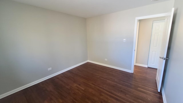 empty room featuring dark wood-type flooring