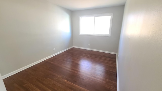 empty room featuring dark wood-type flooring