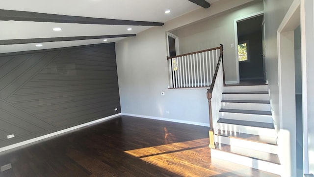 interior space featuring beamed ceiling and hardwood / wood-style floors