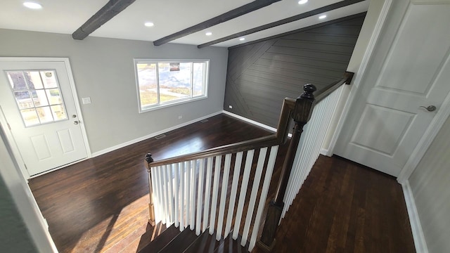 staircase featuring hardwood / wood-style floors and beamed ceiling