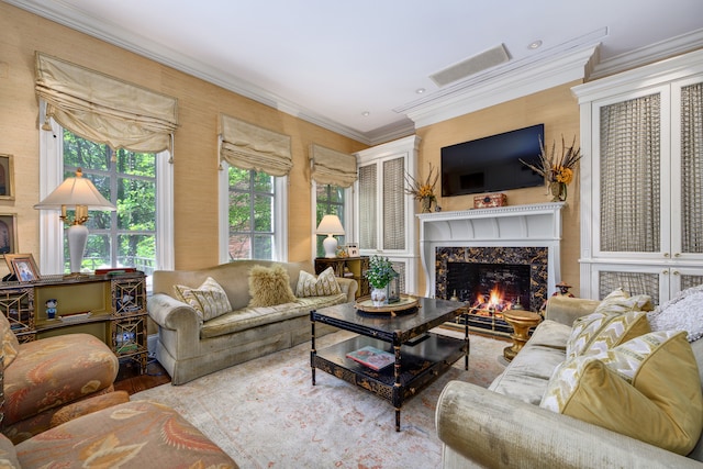 living room with ornamental molding and a fireplace