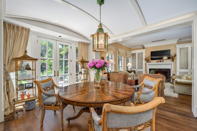 dining space with dark hardwood / wood-style flooring, french doors, and crown molding