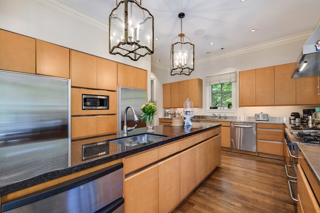 kitchen with built in appliances, sink, dark hardwood / wood-style floors, crown molding, and pendant lighting