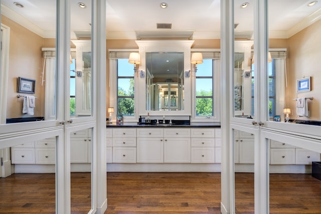 bathroom featuring a wealth of natural light and hardwood / wood-style flooring